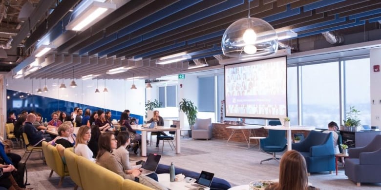 People in a room gather for a team meeting.