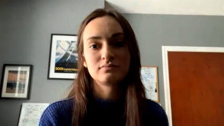 A young woman sitting in a home office stared into a webcam during an interview by videoconference.