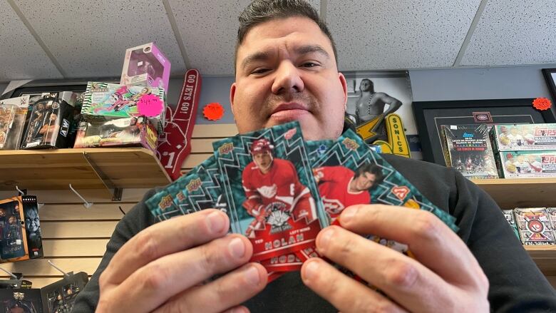 Curtis Howson of Winnipeg's First Row Collectibles holds up the Upper Deck First Peoples Rookie Card set.