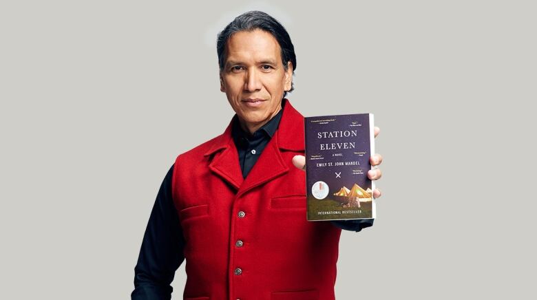 A book cover featuring a white tent under a night sky and a photo of a man with a braid wearing a dress shirt sitting sideways and looking at the camera.