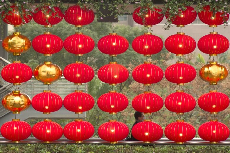 A man walks by lantern decorations ahead of Lunar New Year in Taipei, Taiwan.