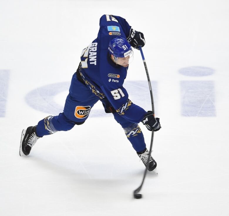 A hockey player shoots a slapshot