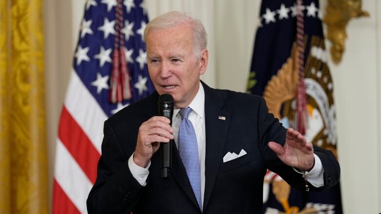 A politician speaks into a microphone.