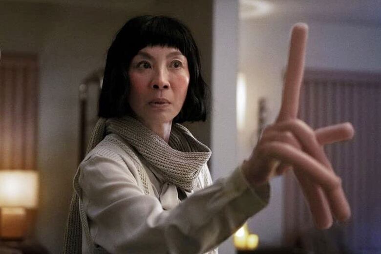 Michelle Yeoh raises a giant finger in a scene from Everything Everywhere All At Once.