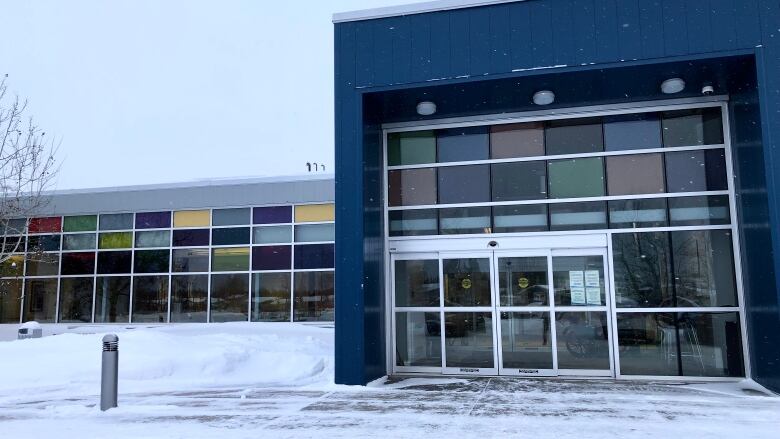 The outside of a building. There is snow on the ground.