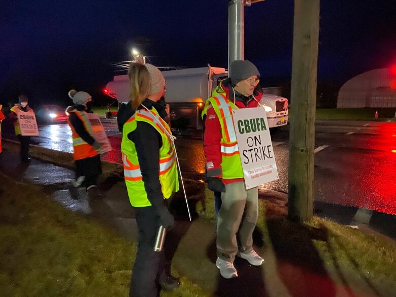 Picketing workers line up on the sidewalk about Cape Breton University on Jan. 27, 2023.