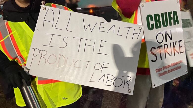 A union protest sign at Cape Breton University reads, 