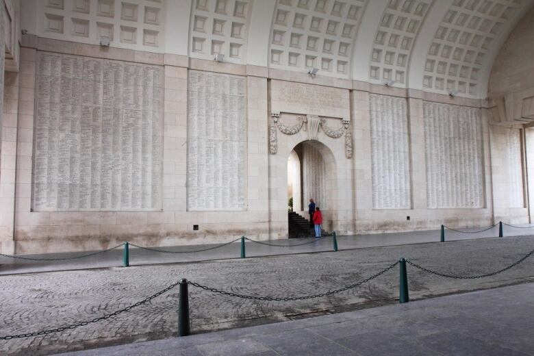 A large stone wall, engraved with thousands of names.