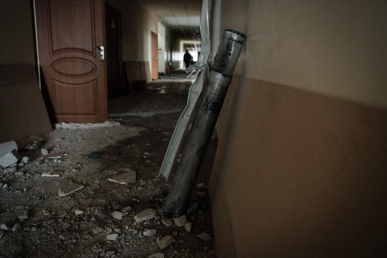 A remaining piece of a rocket is seen inside of an elementary school in Chasiv Yar, Ukraine, after hitting the building's roof.