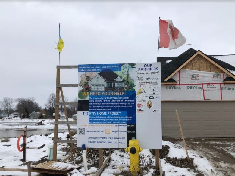 A sign showing community partners of a transitional housing project for Ukrainian refugees