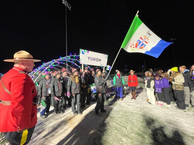 A group of people wave a flag.