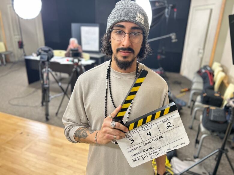 Aaron Sardinha, education and policy coordinator at the Black Cultural Society of P.E.I. pictured with a clapperboard at the organizations' studio in downtown Charlottetown.