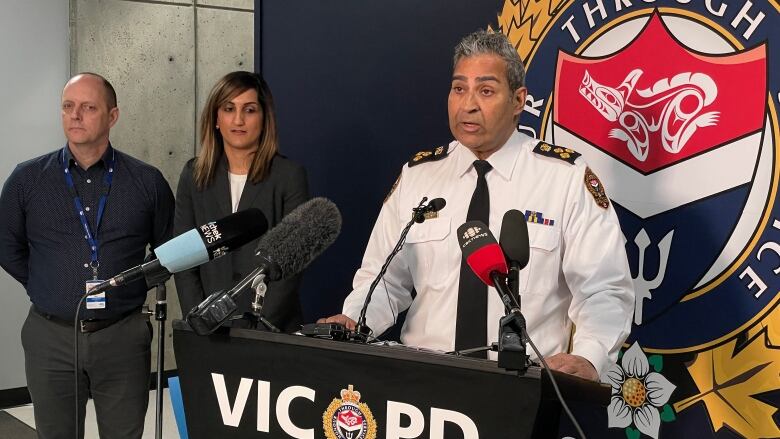 Victoria Police Chief Del Manak is pictured standing at a podium 