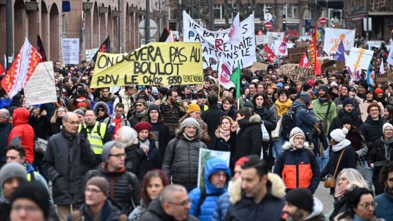 Demonstrators march in Strasbourg, France, against government pension reform.