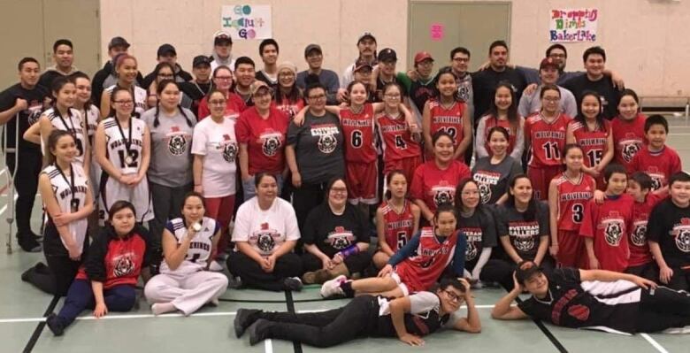 A group photo of dozens of people wearing jerseys.