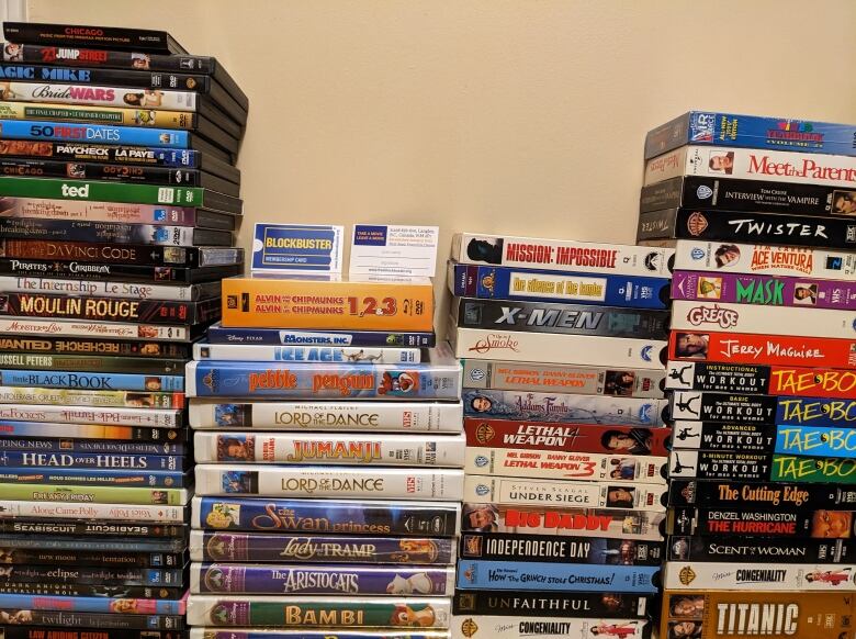 Four side-by-side stacks of various movies of different genres. 