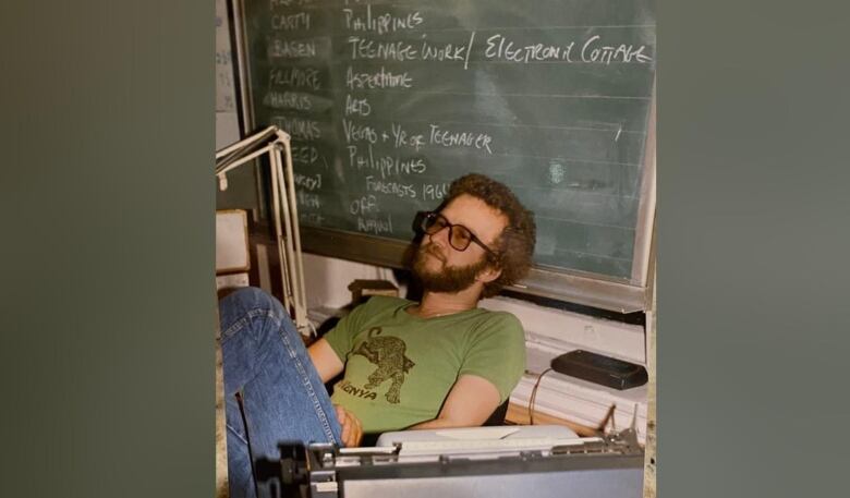 Michael Finlay, longtime CBC radio journalist and producer, is pictured sitting at a desk.