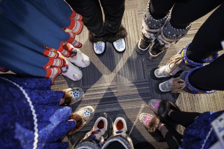 Performers from the circumpolar region show off their footwear.