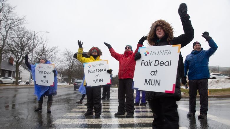 Members of Memorial University Faculty Association wave to supporters as they man a picket line on Prince Philip Drive on the first day of their strike, Monday, January 30, 2023 in St. Johns. 