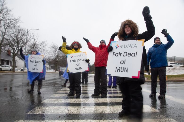 Members of Memorial University Faculty Association wave to supporters as they man a picket line on Prince Philip Drive on the first day of their strike, Monday, January 30, 2023 in St. Johns. 