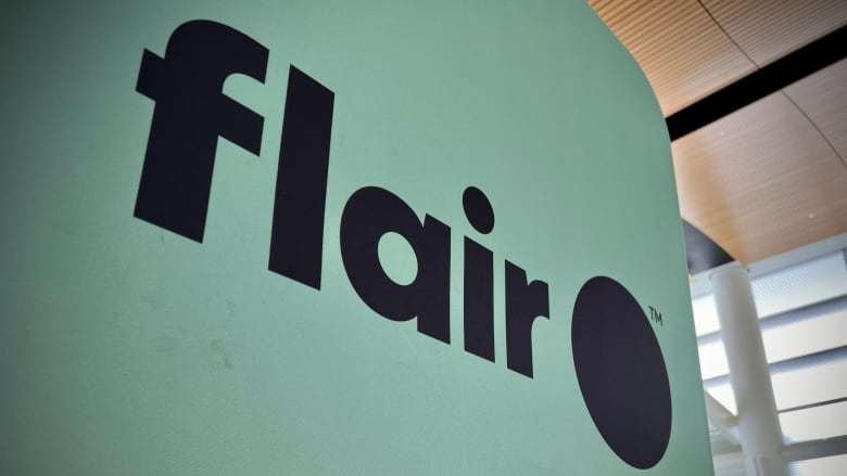 A light green sign that says 'flair' and 'flyflair.com' on it.