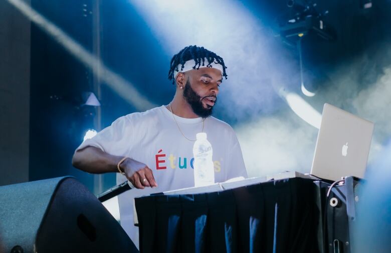 A man plays a DJ set.