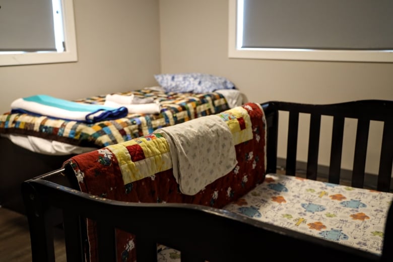 A crib and single bed can be seen in a unit inside a shelter in Morinville, Alberta.