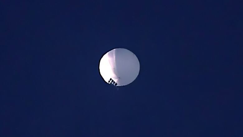 A high altitude balloon floats over Billings, Mont., on Wednesday, Feb. 1, 2023. The U.S. is tracking a suspected Chinese surveillance balloon that has been spotted over U.S. airspace for a couple days, but the Pentagon decided not to shoot it down due to risks of harm for people on the ground, officials said Thursday, Feb. 2, 2023. The Pentagon would not confirm that the balloon in the photo was the surveillance balloon.