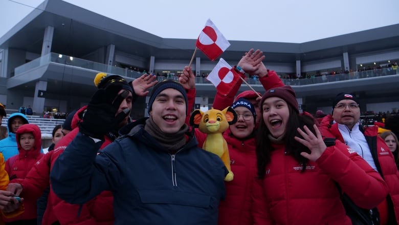 Group of people waving Greenland flags.