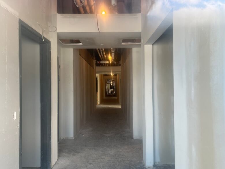 An unfinished hallway in a hotel under construction.