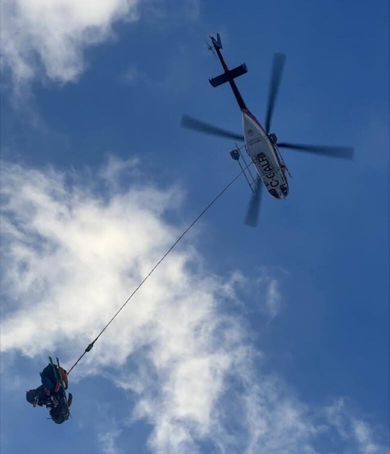 a helicopter with a long rope coming 