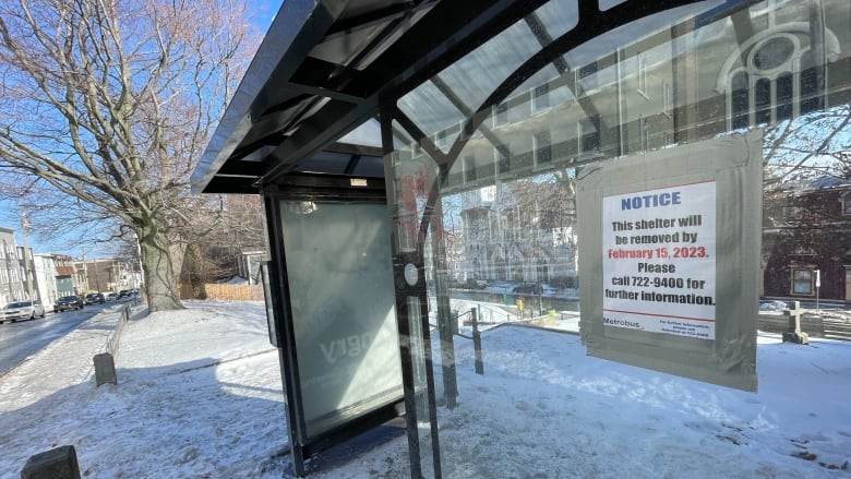 A sign on a bus shelter reads 