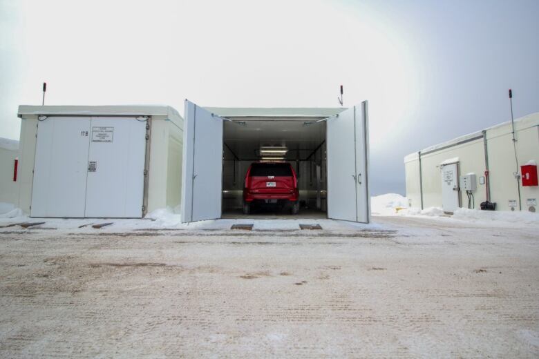 A red vehicle in a large freezer.