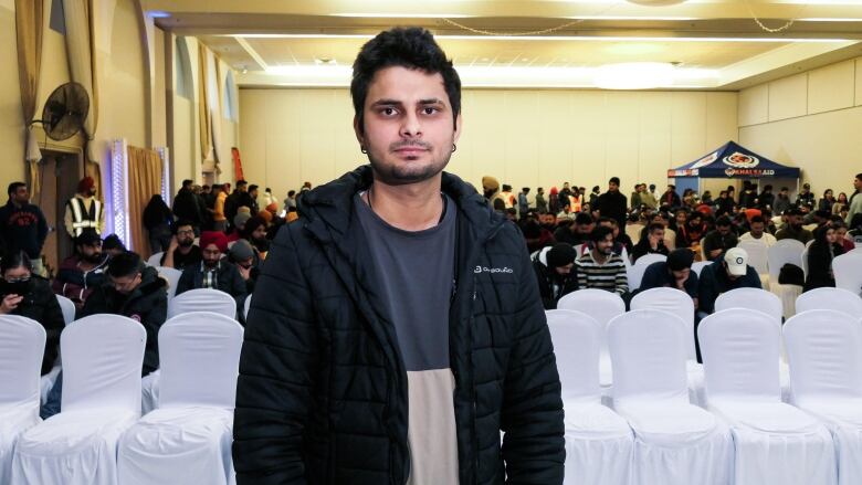 A man, Prince Bhatia, stands and poses for a photo.