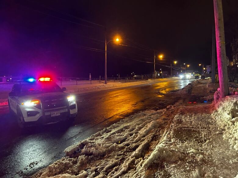 A police cruiser blocking the entrance to a street.