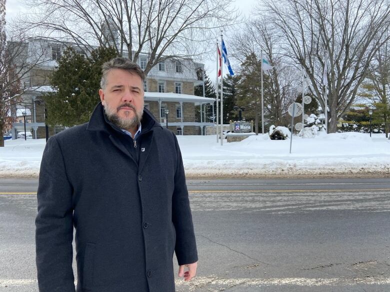 Man standing in front of street and building