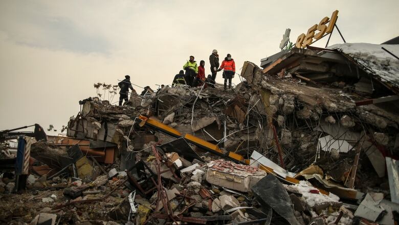 Rescuers search for survivors in the rubble.