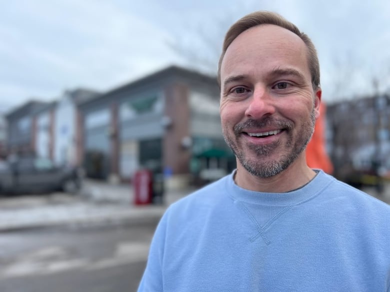 A man named Patrick Sojka is shown in focus, standing in front of a Stabucks location, which is out of focus behind him.