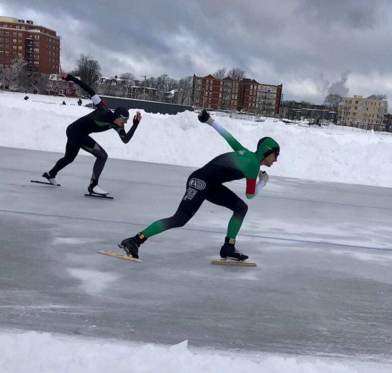 Two skaters on the open track at the outdoor Halifax Oval. 