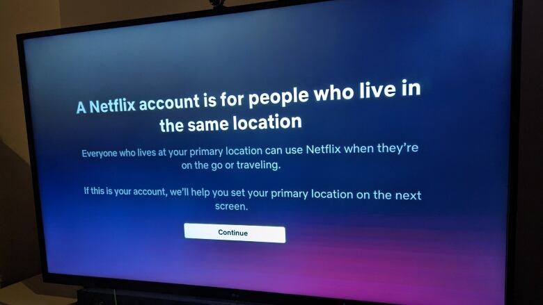 A TV screen shows an error message from Netflix about how the system is only designed to be used by people at the same residence.