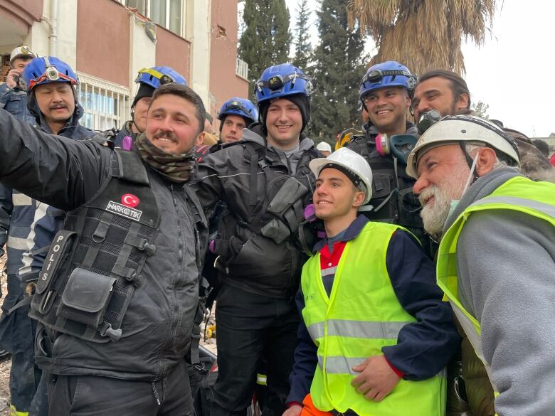 A group of men pose for a photo.