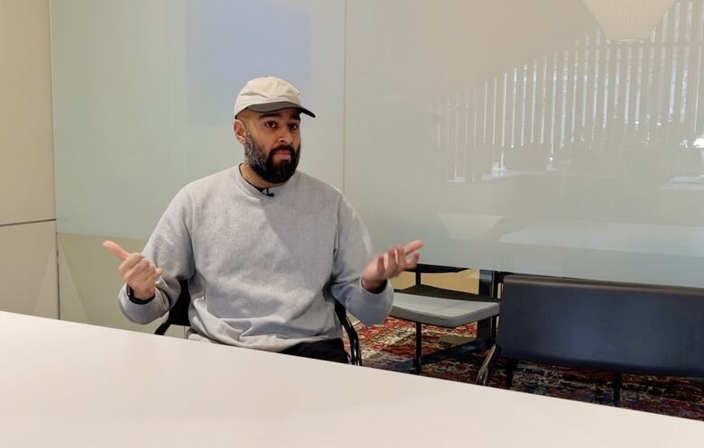 Alkarim Devani is sitting in a boardroom. He's the co-founder of RNDSQR, an inner-city builder.