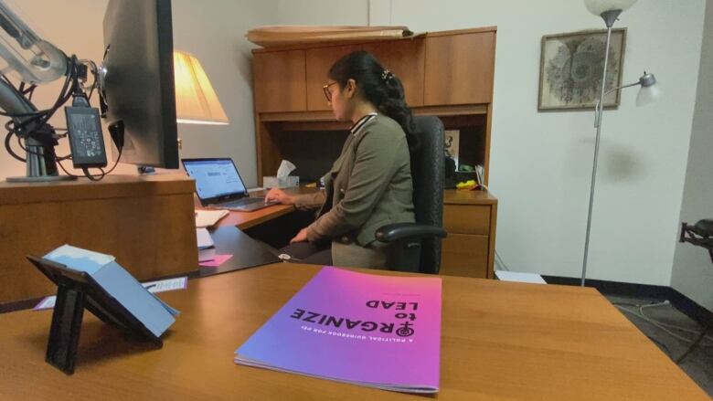 P.E.I. Coalition for Women in Government executive director Sweta Daboo goes through information on a computer.