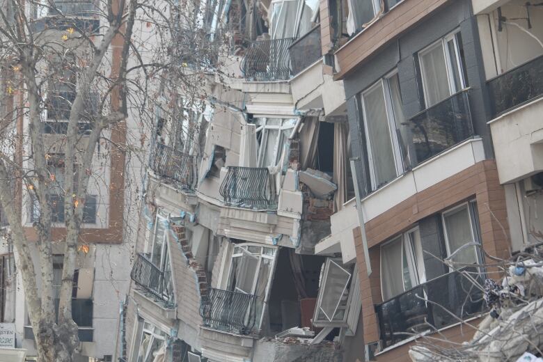 Several apartment buildings collapse into each other.