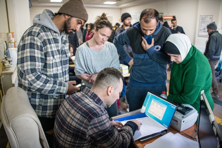 People in Turkey look at a computer screen.