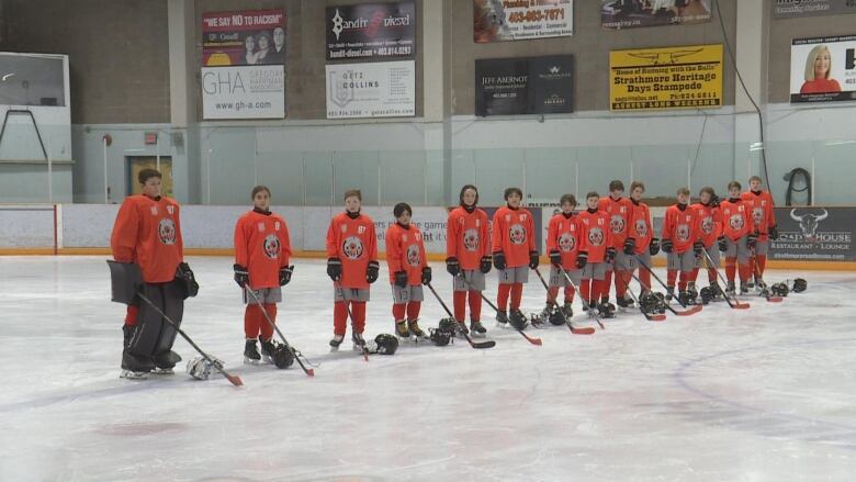 A group of hockey players wearing orange jerseys