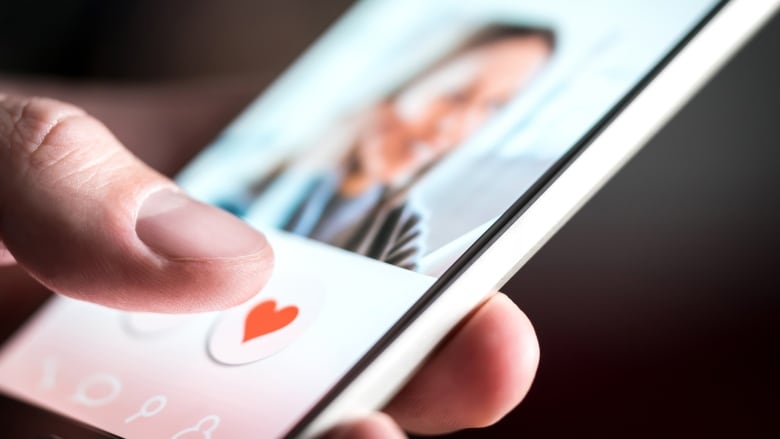 Close-up of a person using a swipe-based dating app.