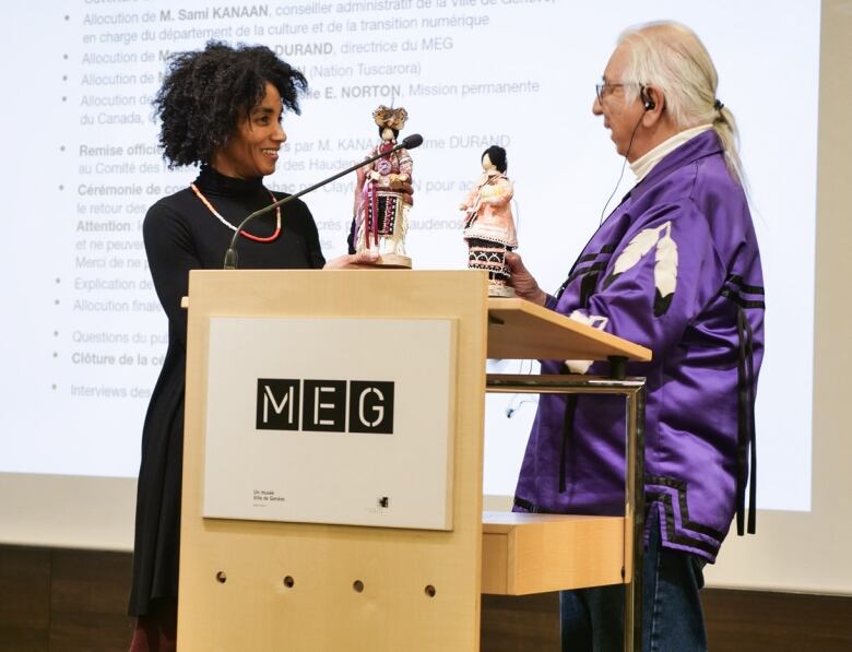 Muse d'ethnographie de Genve (MEG) director Carine Ayl Durand and Haudenosaunee External Relations Committee member Kenneth Deer holding cornhusk dolls. 