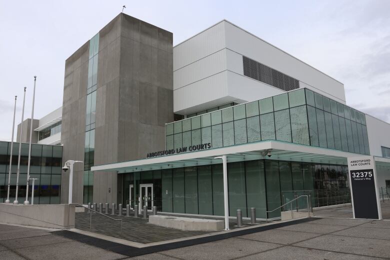 A modern, glass courthouse is pictured on an overcast day.