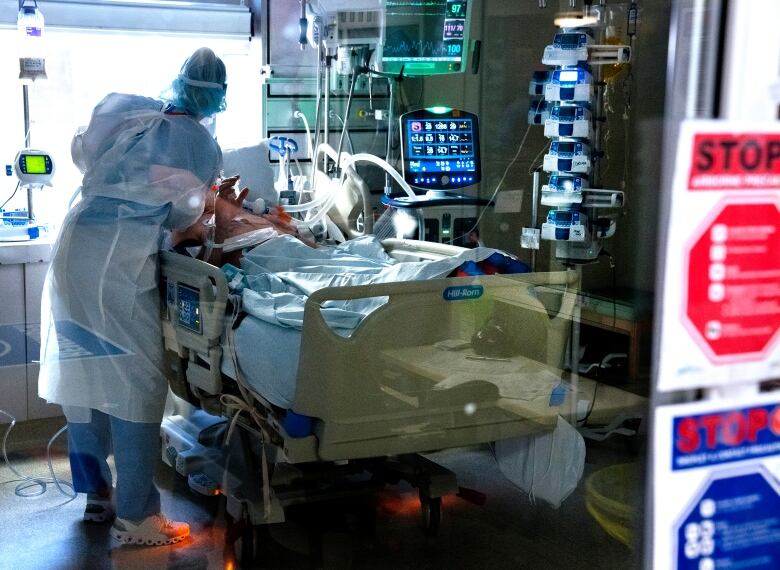 A nurse is seen working with a patient at the Halifax Infirmary in Halifax.